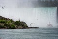 Tour boat in the mist under Horseshoe Falls on the Niagara River Royalty Free Stock Photo