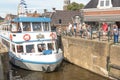 Tour boat by the old lock in Lemmer in Friesland in the north of Netherlands.