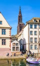 A tour boat stationing at a pier near Notre-Dame cathedral in Strasbourg, France Royalty Free Stock Photo