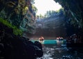 Tour by boat tourists in a cave with an underground lake Melissani on the island of Kefalonia, Greece