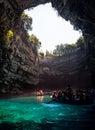 Tour by boat tourists in a cave with an underground lake Melissani on the island of Kefalonia, Greece