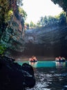 Tour by boat tourists in a cave with an underground lake Melissani on the island of Kefalonia, Greece