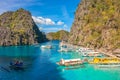 Tour boats by the shore at Coron island, Philippines. Fishermen boats by the sea aerial view. Royalty Free Stock Photo