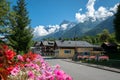 Tour Du Mont Blanc with colorful houses next to a garden with pink flowers