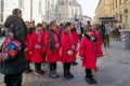 Tour group of Asian girls stands near Medieval religious building of the baptistery