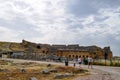 Tour groups on the ruins of Hierapolis. Tourists are shown the ruins of the ancient city