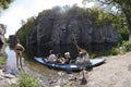 Tour guide-waterman pushing canoe with tourists aboard out into the river. Buksky canyon. Cherkasskaya oblast, Ukraine Royalty Free Stock Photo