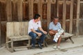 Tour guides sit at the entrance to one of the hostels in Chiang Khan, Thailand.