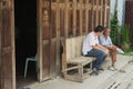 Tour guides sit at the entrance to one of the hostels in Chiang Khan, Thailand.