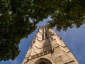 Tour Saint Jacques behind summer foliage; blue sky in background