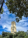 Tour Saint Jacques in Paris, France, framed by summer foliage