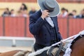 Tourada - Cavaleiro on the horseback covers his face with his hat