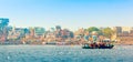 Tourboat sails along ghats of Ganges river in Varanasi early in the morning Royalty Free Stock Photo
