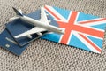 Tourim flight to the Grean Britain concept. Vacation in the United Kingdom. Composition of the UK flag, passport and toy