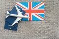 Tourim flight to the Grean Britain concept. Vacation in the United Kingdom. Composition of the UK flag, passport and toy