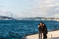 A tourish couple taking pictures at the Corniche park at Uskudar, Istanbul, Turkey, on the Anatolian shore of the Bosphorus