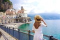 Tourism on Amalfi Coast. Back view of beautiful fashion girl enjoying view of Atrani village on Amalfi Coast, Italy. Summer Royalty Free Stock Photo