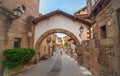 Tourism in Barceloneta - tourists & people walk down a street of small town on interior of Barcelona. Charming cafes, shops, & br Royalty Free Stock Photo