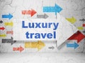 Tourism concept: arrow with Luxury Travel on grunge wall background