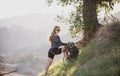 Tourism concept. Woman tourist hiker with backpack at hills. Girl climbing hiking in mountains with backpacking tools