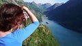 Tourist taking photo of fjord landscape, Norway Royalty Free Stock Photo