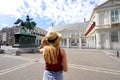 Tourism in Holland. Back view of young tourist woman visiting Noordeinde Palace in The Hague, Netherlands