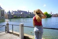 Tourism in Holland. Young traveler girl looking at the complex of buildings of Binnenhof in The Hague, Netherlands