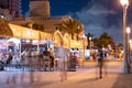 Tourism on Hollywood Beach FL night photo tourists sitting on tables eating and drinking