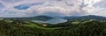 The tourism hotspot lake Tegernsee from above in a wide panoramic view at a warm and cloudy summer day. Royalty Free Stock Photo