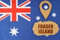 The flag of Australia has a geolocation symbol and a sign with the inscription - Fraser Island