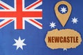 The flag of Australia has a geolocation symbol and a sign with the inscription - Newcastle Royalty Free Stock Photo