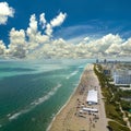 Tourism infrastructure in southern USA. South Beach sandy surface with tourists relaxing on hot Florida sun. Miami Beach Royalty Free Stock Photo