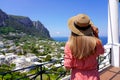 Tourism in Italy. Back view of beautiful girl looking at Capri sight from terrace, Capri Island, Italy Royalty Free Stock Photo