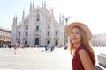 Tourism in Italy. Beautiful smiling girl sitting with Milan Cathedral on the background in Italy Royalty Free Stock Photo