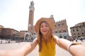 Tourism in Italy. Selfie picture of tourist girl visiting Siena historic town of Tuscany, Italy