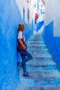 Woman tourist in beautiful blue street in Chefchaouen Royalty Free Stock Photo