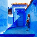 Woman tourist in beautiful blue street in Chefchaouen Royalty Free Stock Photo