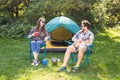 People, tourism and nature concept - Couple having fun on camping trip Royalty Free Stock Photo