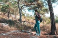 Tourism and outdoor activities. A woman with a backpack on her back is engaged in walking in the woods Royalty Free Stock Photo