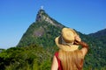 Tourism in Rio de Janeiro. Back view of tourist woman looking at Christ the Redeemer statue on the top of Corcovado mountain, Rio Royalty Free Stock Photo