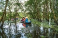 Tourism rowing boat in cajuput forest in floating water season in Mekong delta, Vietnam