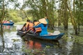 Tourism rowing boat in cajuput forest in floating water season in Mekong delta, Vietnam