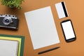 Tourism, travel concept. Office desk table with notepad, camera and supplies. Top view. Copy space for text. Royalty Free Stock Photo