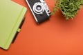 Tourism, travel concept. Office desk table with notepad, camera and supplies. Top view. Copy space for text. Royalty Free Stock Photo