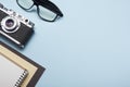 Tourism, travel concept. Office desk table with notepad, camera and supplies. Top view. Copy space for text. Royalty Free Stock Photo