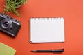 Tourism, travel concept. Office desk table with notepad, camera and supplies. Top view. Copy space for text. Royalty Free Stock Photo