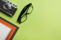 Tourism, travel concept. Office desk table with notepad, camera and supplies. Top view. Copy space for text. Royalty Free Stock Photo