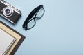 Tourism, travel concept. Office desk table with notepad, camera and supplies. Top view. Copy space for text. Royalty Free Stock Photo