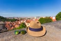 Tourism, travel, holidays and summer concept - Hat and sunglass against an old city background.