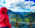 Tourist looking through binoculars in mountains, Norway